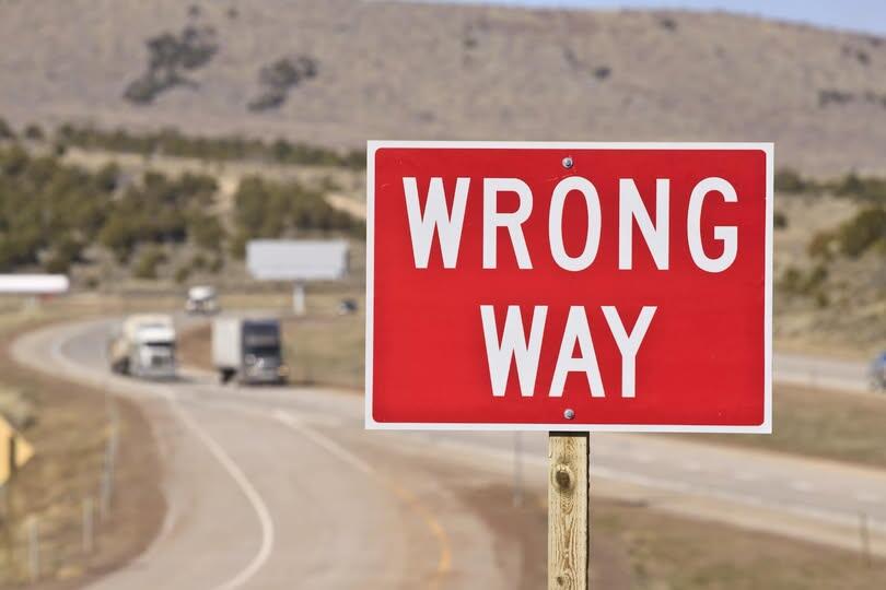 Wrong Way highway sign posted along highway