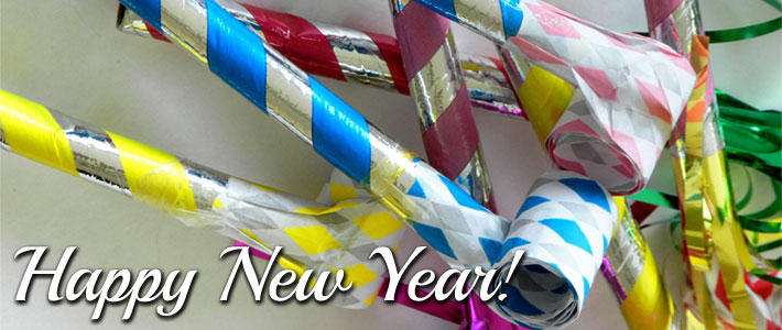 party blowers and text saying happy new year